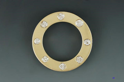 14k yellow gold and brilliant diamond open circle brooch.